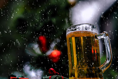 Close-up of waterdrops on glass against blurred background