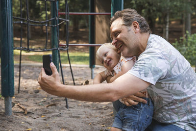 Father and son taking selfie