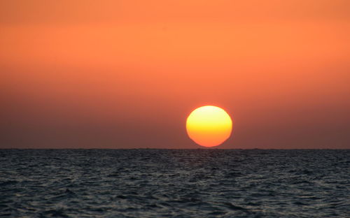 Scenic view of sea against romantic sky at sunset