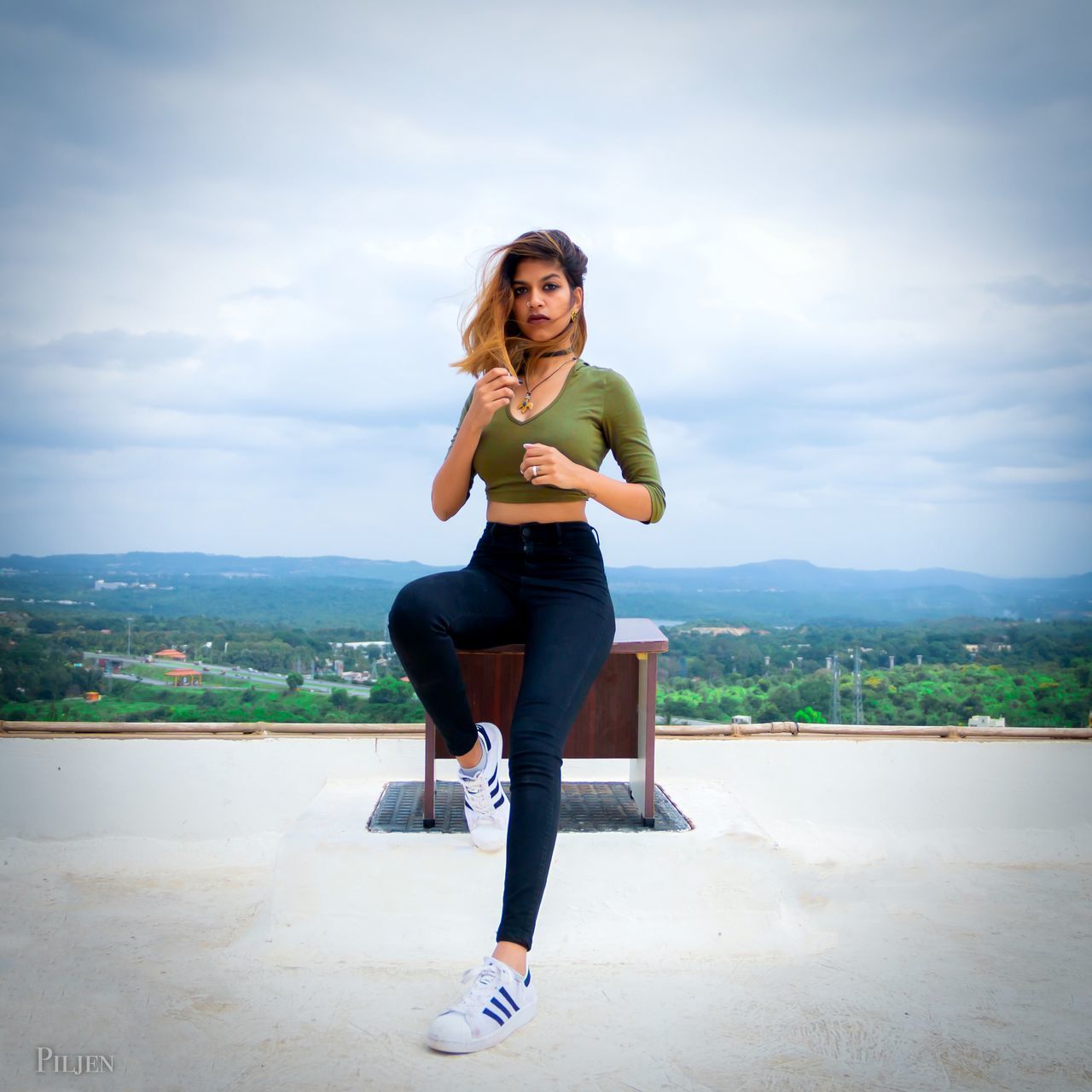 PORTRAIT OF WOMAN STANDING AGAINST SKY