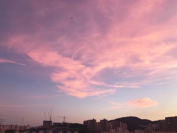 Silhouette buildings against sky during sunset