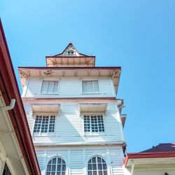 Low angle view of building against blue sky