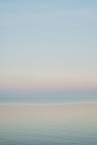 Scenic view of sea against clear sky during sunset
