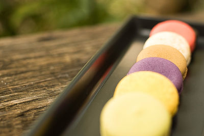 Colorful and delicious french macaron cookies varieties on a wooden table