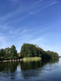 Scenic view of lake against blue sky