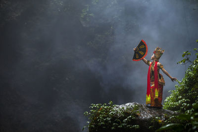 Woman in traditional clothing on mountain