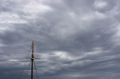 Low angle view of electricity pylon against sky