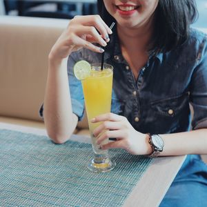 Young woman drinking cocktail