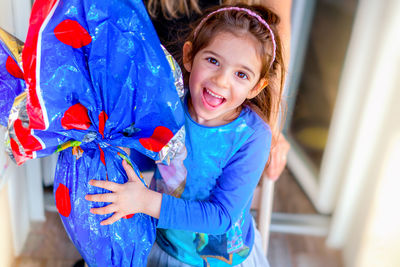 Portrait of smiling girl holding while standing outdoors