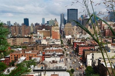 Cityscape against cloudy sky