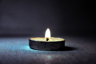 Close-up of tea light candles on table