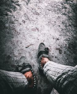 Low section of man standing on ground