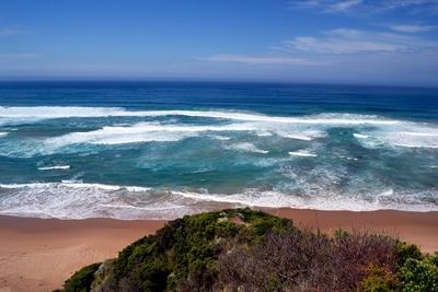 Scenic view of beach against cloudy sky