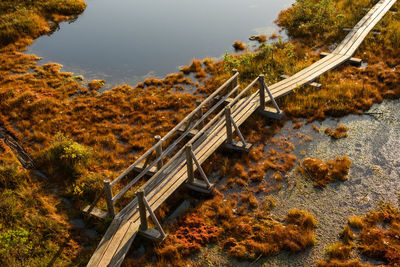 High angle view of bridge over road by trees