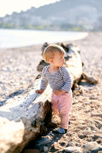 Cute boy standing on rock