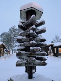 Built structure on snow covered field against sky