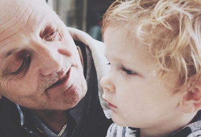 Close-up of grandfather with grandson