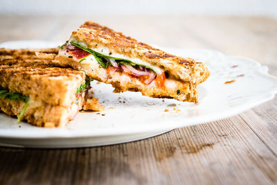 Close-up of grilled sandwich in plate on table