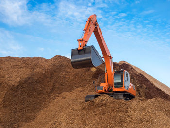 Low angle view of construction worker on field against sky