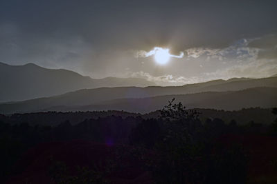 Scenic view of silhouette mountains against sky at sunset