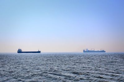 Ship sailing on sea against sky