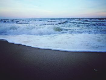 Scenic view of beach against sky during sunset