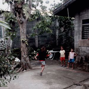 People playing in front of building