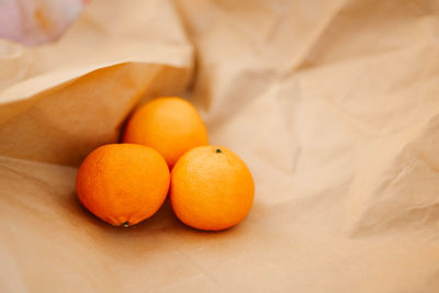 Citrus fruits oranges lie on craft paper. fragrant tangerines