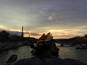 Boats in river at sunset