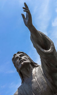 Low angle view of bird statue against sky