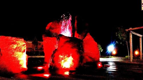 Illuminated fountain at night