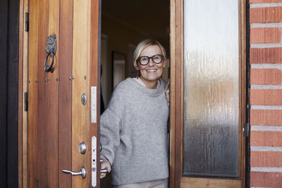 Smiling woman at front door