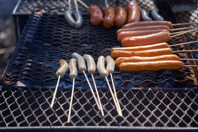 Grilled sausages outdoor on vintage rusted grill.