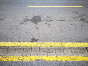 High angle view of yellow road marking on street