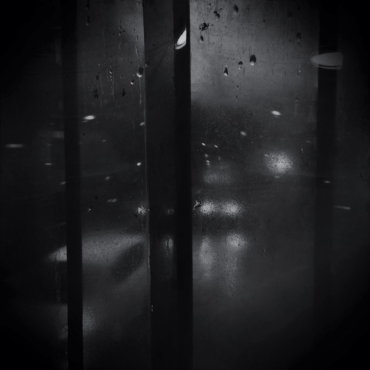 indoors, window, wet, transparent, rain, glass - material, drop, water, reflection, night, weather, glass, dark, built structure, looking through window, close-up, season, no people, raindrop, monsoon