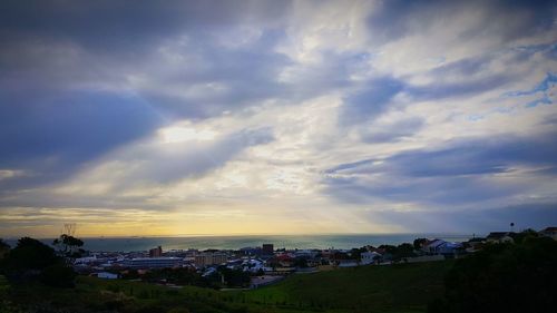 Scenic view of townscape against sky during sunset