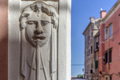 Close-up of sculpture against building