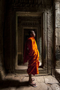 Novice monk in ruined building