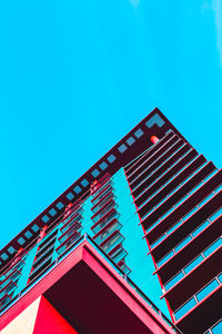 Low angle view of modern building against blue sky