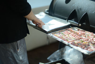 Midsection of man preparing food