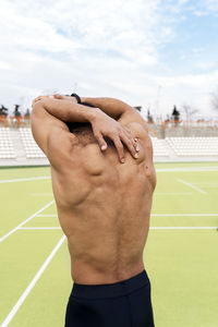 Midsection of man wearing hat against sky