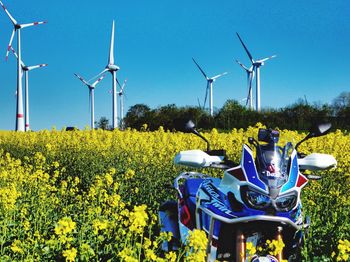 Traditional windmill on field against sky