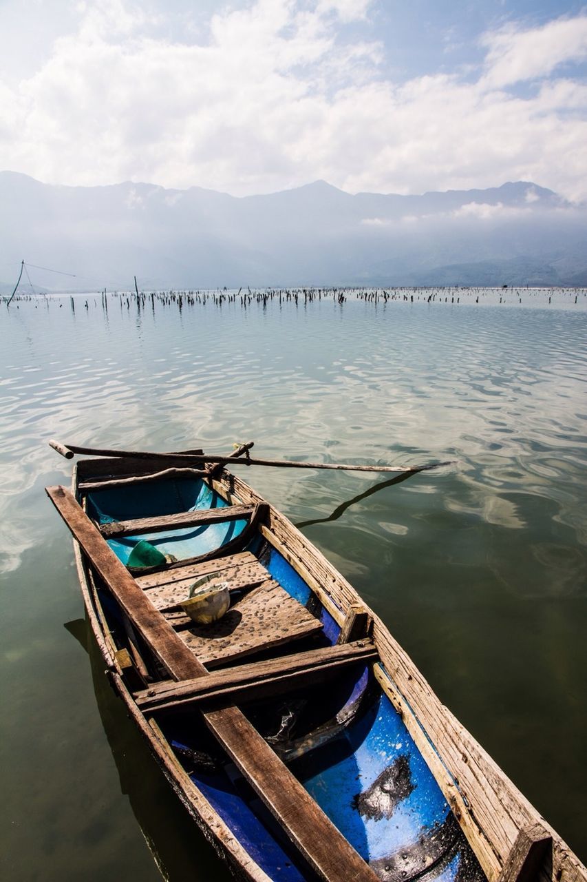 nautical vessel, water, boat, moored, transportation, mode of transport, sky, lake, pier, tranquility, cloud - sky, sea, nature, tranquil scene, day, mountain, cloud, wood - material, jetty, waterfront