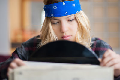 Close-up of young woman choosing vinyl records