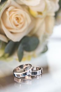Close-up wedding ring with rose background