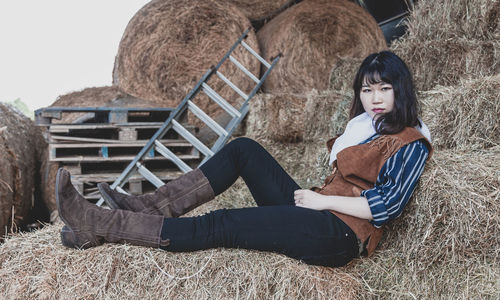 Portrait of woman sitting on field