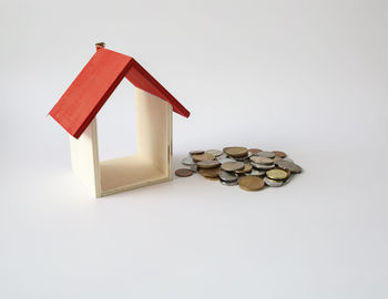 Stack of coins on floor against white background