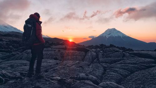 Full length of man standing on landscape during sunset