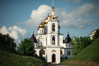 Church by building against sky