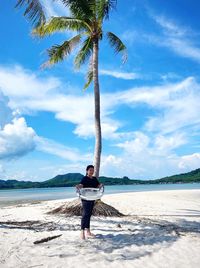 Full length of man standing on beach against sky